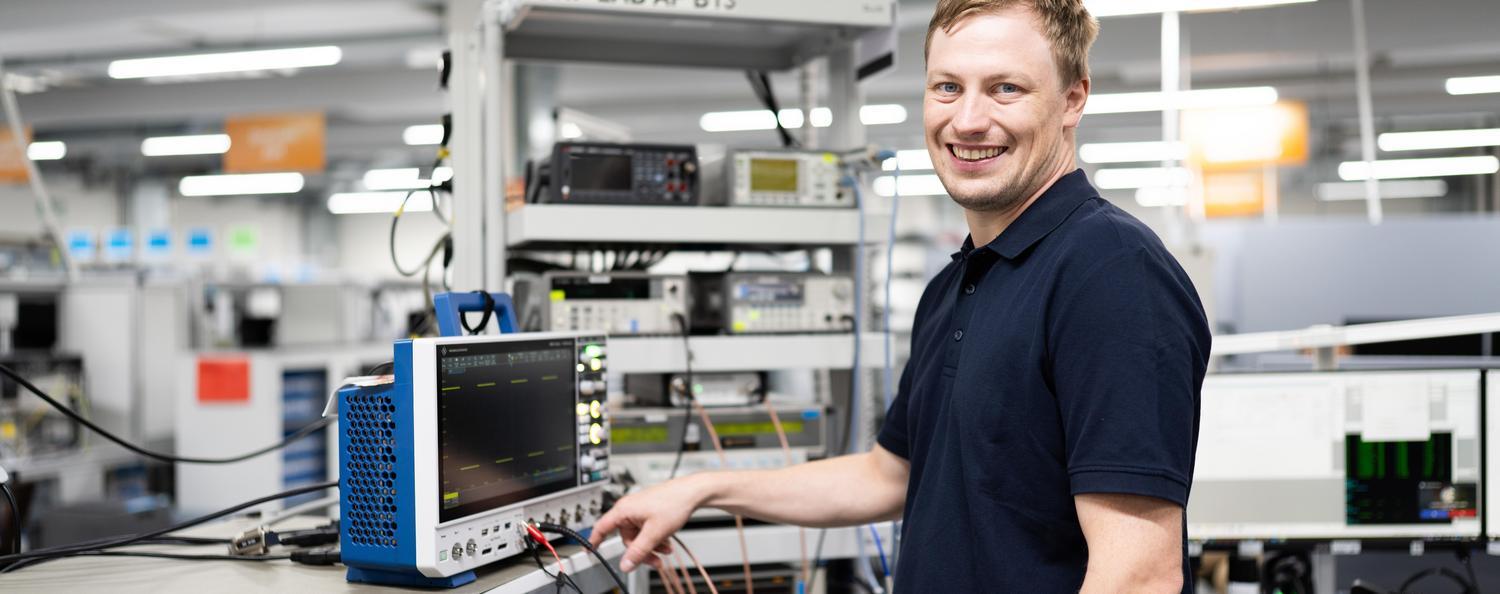 Calibration of electrical measuring instruments A man in a laboratory calibrates an oscilloscope