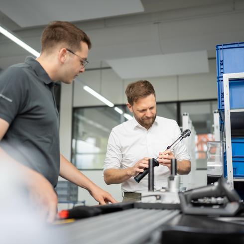 Statistical Process Control (SPC) Two men are calibrating a torque wrench